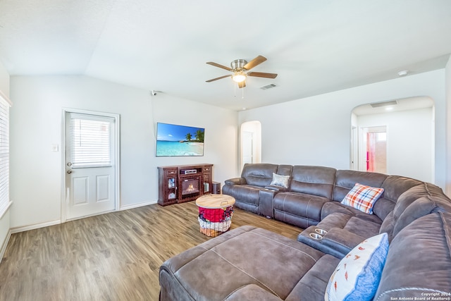 living room with hardwood / wood-style floors, ceiling fan, and lofted ceiling