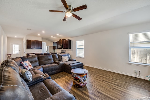 living room featuring ceiling fan, lofted ceiling, and dark wood-type flooring