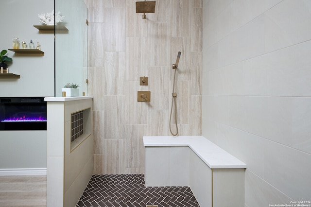 bathroom featuring a shower, tile walls, and hardwood / wood-style flooring