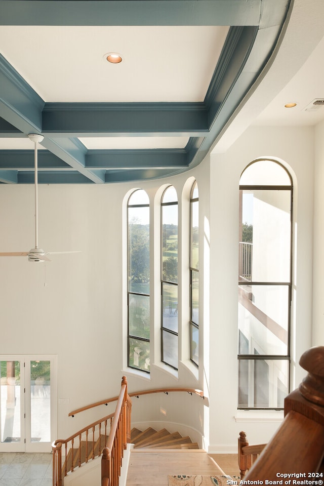 stairs with hardwood / wood-style floors, ceiling fan, and ornamental molding