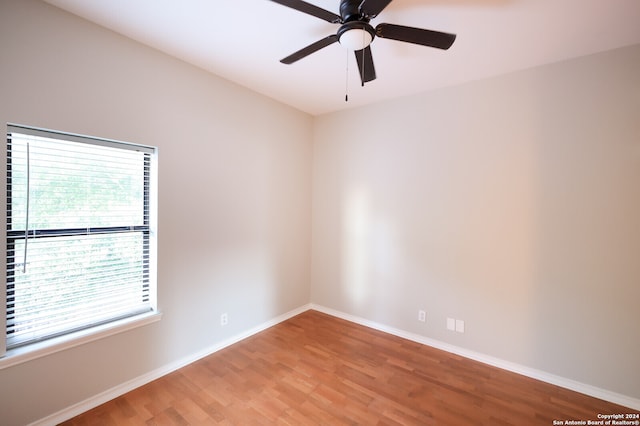 spare room featuring hardwood / wood-style floors and ceiling fan