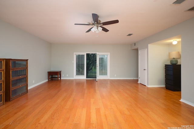 unfurnished living room featuring ceiling fan and light hardwood / wood-style flooring