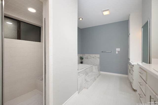 bathroom featuring plus walk in shower and vanity