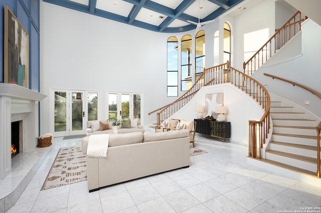 living room with a high ceiling, coffered ceiling, french doors, a premium fireplace, and beamed ceiling