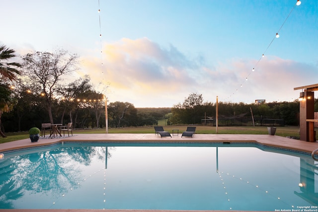 view of pool at dusk