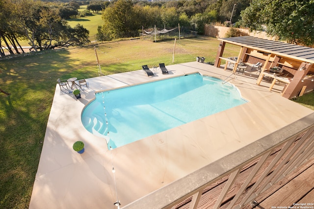 view of pool with a lawn and a patio