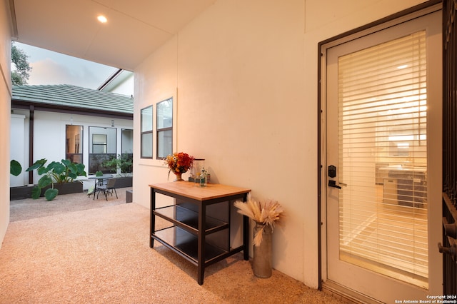 hallway featuring carpet floors and a skylight