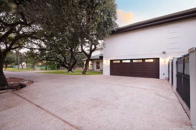 property exterior at dusk featuring a garage