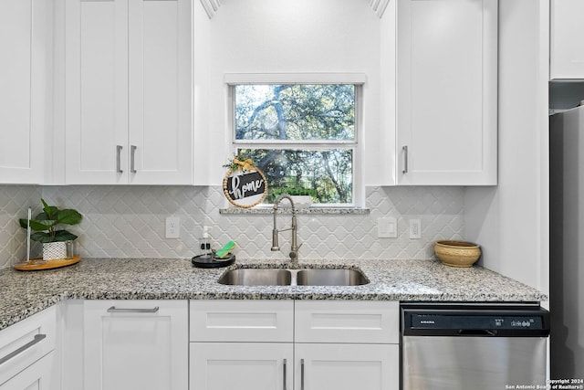 1153 Singing Hills Dr, Canyon Lake, TX 78133 - kitchen with dishwasher, a sink, white cabinetry, tasteful backsplash, and light stone counters