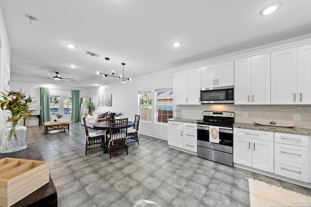 kitchen with white cabinetry, ceiling fan, tasteful backsplash, light stone counters, and appliances with stainless steel finishes