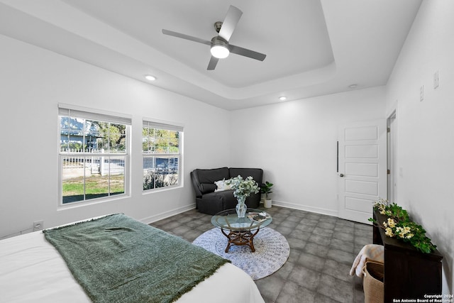 bedroom featuring a tray ceiling and ceiling fan