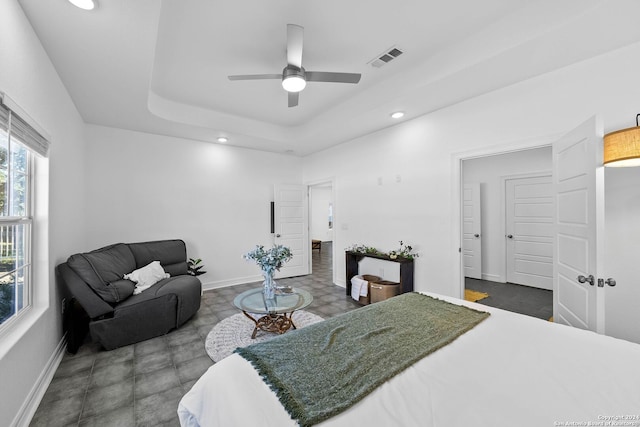 bedroom featuring ceiling fan and a tray ceiling