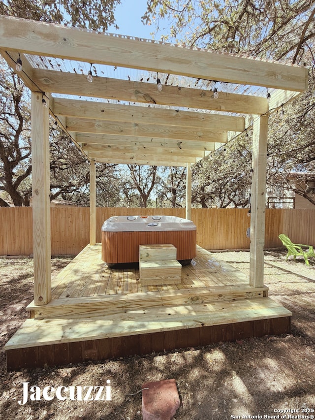 1153 Singing Hills Dr, Canyon Lake, TX 78133 - wooden deck with a hot tub and a fenced backyard