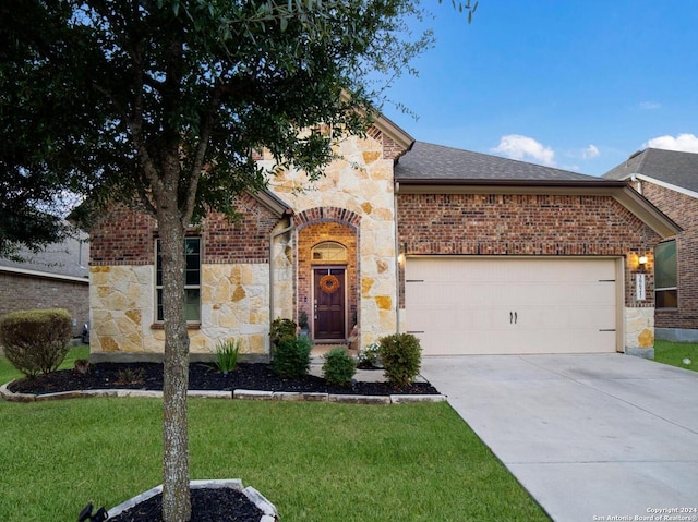 view of front facade with a front yard and a garage