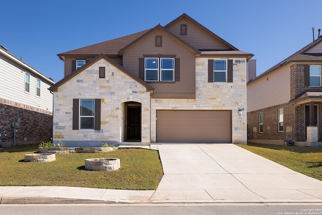 view of front of house featuring a front lawn and a garage