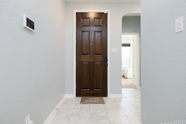 foyer entrance with light tile patterned floors