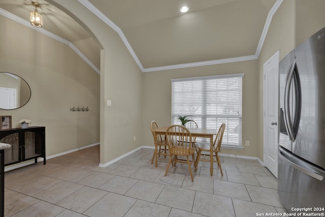 dining room featuring crown molding and vaulted ceiling