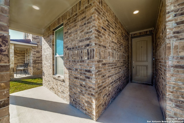 view of exterior entry featuring covered porch