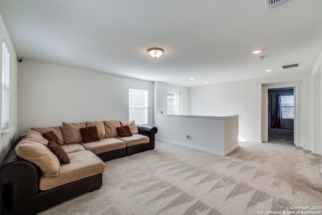 living room featuring light carpet and a healthy amount of sunlight