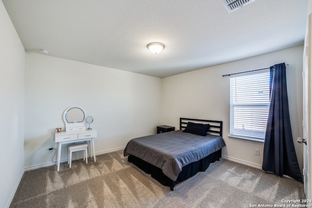 carpeted bedroom with a textured ceiling