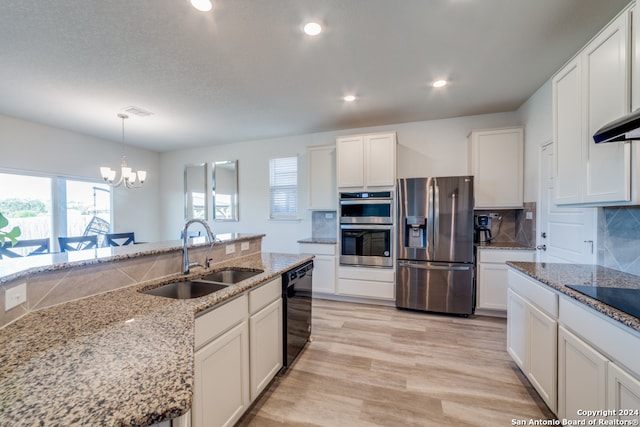 kitchen featuring black appliances, white cabinets, sink, light stone countertops, and decorative light fixtures