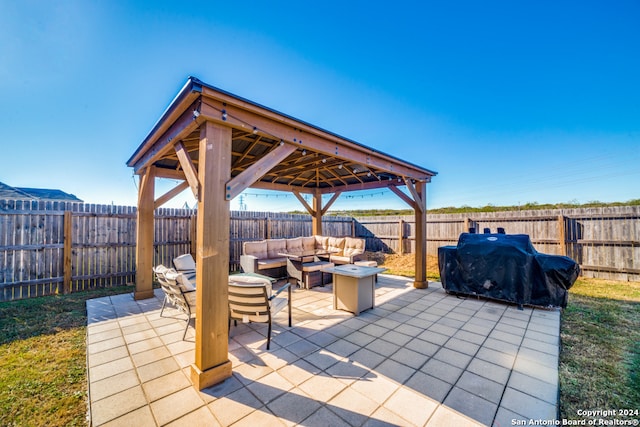 view of patio / terrace with area for grilling and an outdoor living space with a fire pit