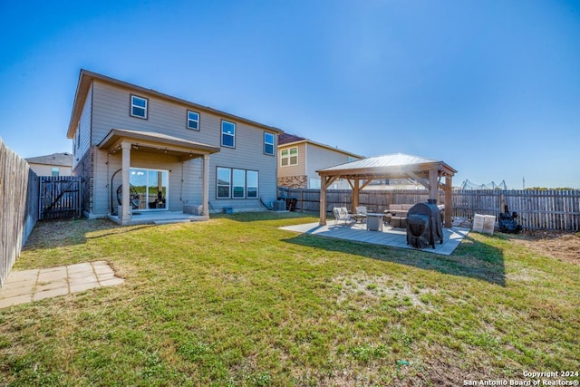 rear view of house with a gazebo, a lawn, and a patio