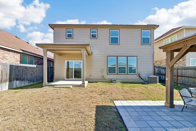 back of house with a patio, central AC unit, and a lawn