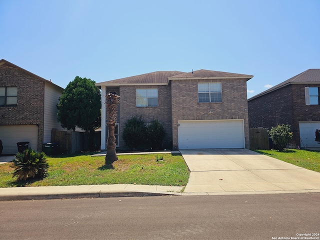 front facade featuring a front yard and a garage