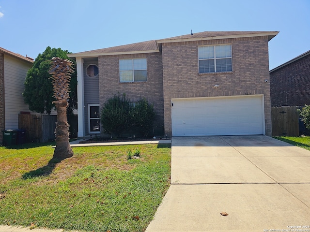 front of property featuring a front yard and a garage