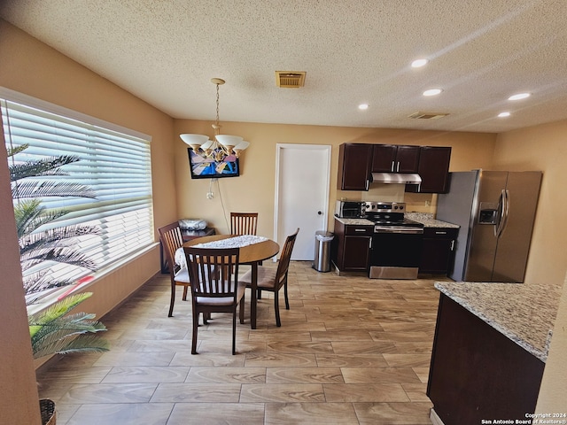 dining space with a chandelier, a textured ceiling, and light hardwood / wood-style flooring