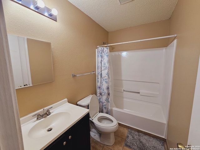 full bathroom featuring tile patterned floors, vanity, a textured ceiling, shower / bath combo with shower curtain, and toilet