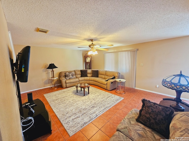 tiled living room with a textured ceiling and ceiling fan