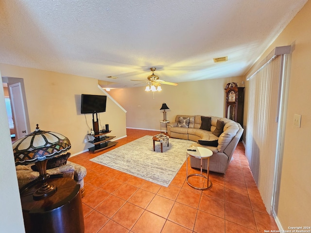 tiled living room with a textured ceiling and ceiling fan