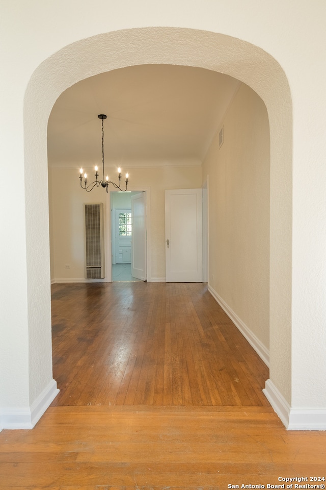 interior space with a chandelier and wood-type flooring