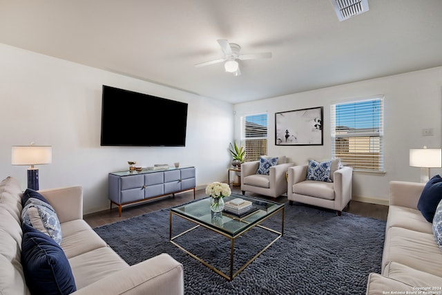 living room featuring dark hardwood / wood-style flooring and ceiling fan