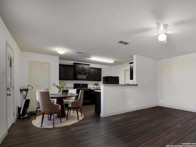 kitchen with kitchen peninsula, ceiling fan, dark hardwood / wood-style flooring, and black appliances