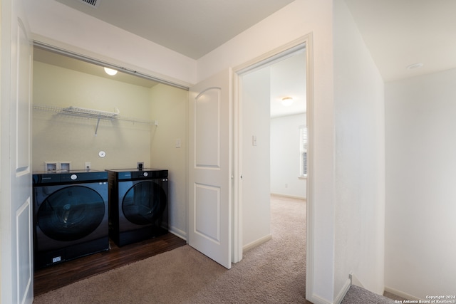 clothes washing area featuring carpet flooring and washer and clothes dryer