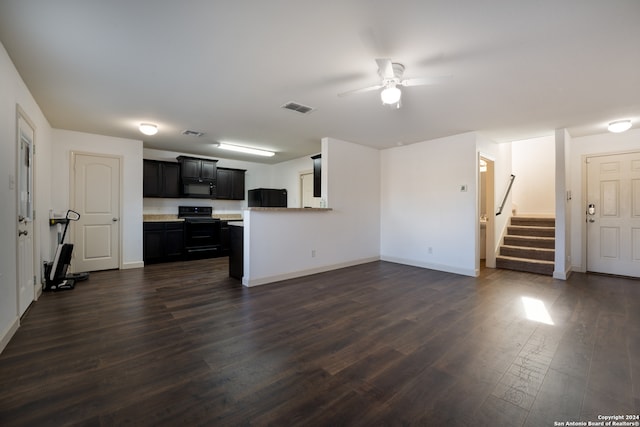 unfurnished living room featuring ceiling fan and dark wood-type flooring