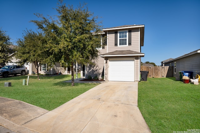 view of front of home with a front yard and a garage