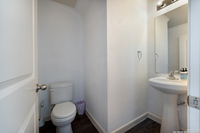 bathroom with wood-type flooring and toilet