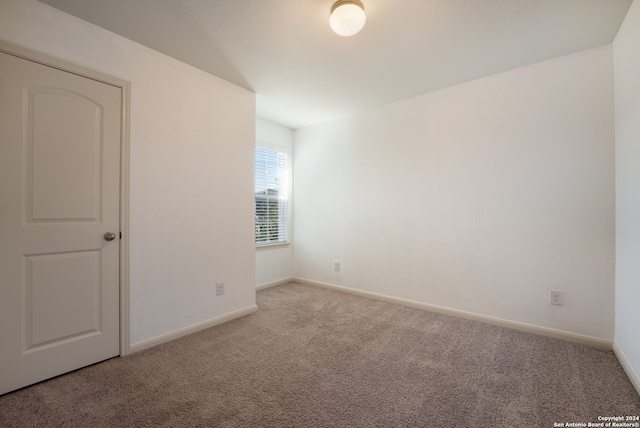 unfurnished room featuring light colored carpet