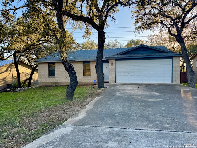 single story home with a garage and a front yard