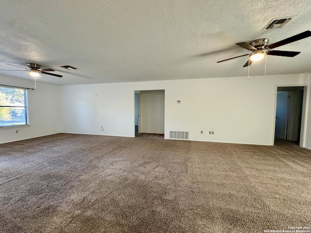 unfurnished room with carpet flooring, ceiling fan, and a textured ceiling