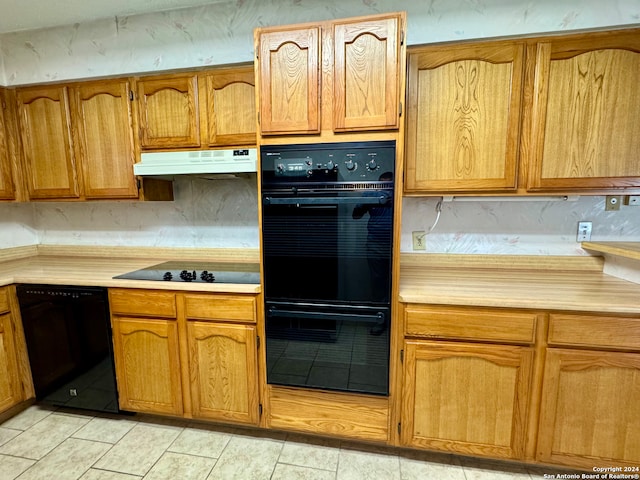 kitchen featuring black appliances and light tile patterned floors