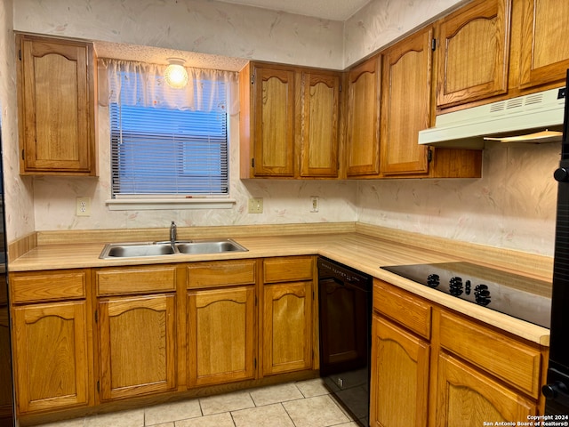 kitchen featuring black appliances, light tile patterned floors, and sink