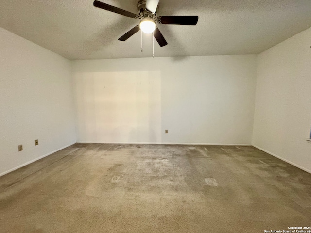 spare room featuring carpet flooring, ceiling fan, and a textured ceiling