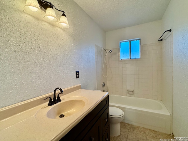 full bathroom with tile patterned floors, vanity, a textured ceiling, tiled shower / bath combo, and toilet