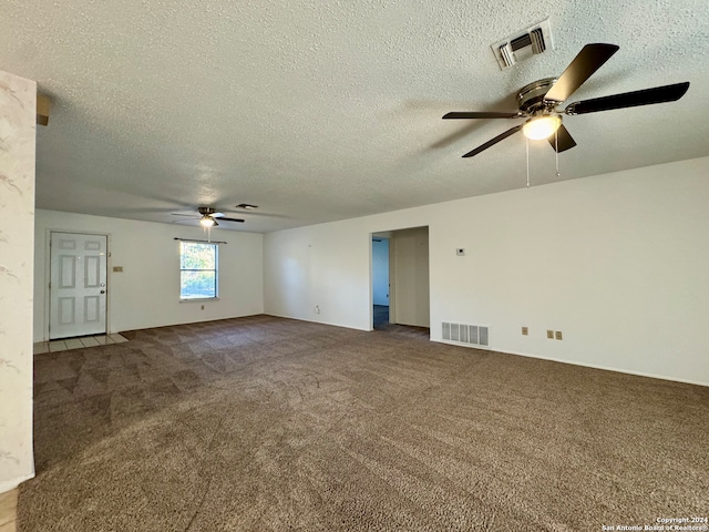 carpeted empty room with a textured ceiling and ceiling fan