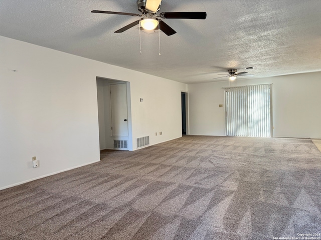 carpeted empty room featuring ceiling fan and a textured ceiling